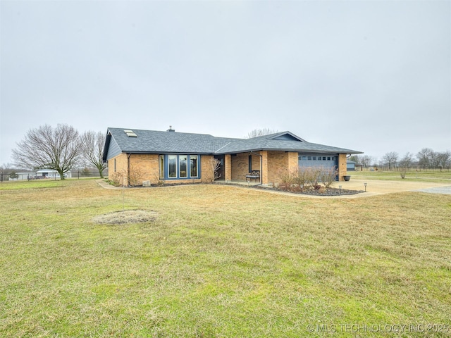 ranch-style home featuring a garage and a front yard