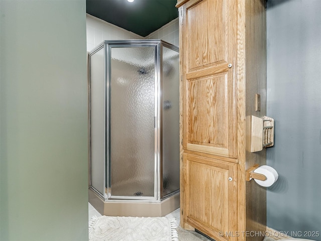 bathroom featuring a shower with door