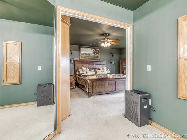 bedroom featuring light carpet and ceiling fan