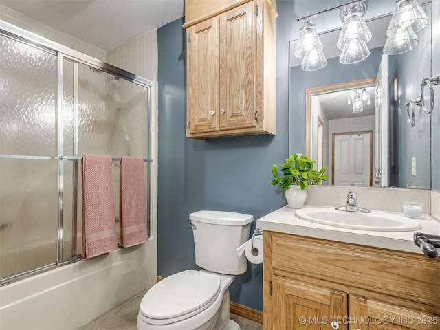 full bathroom with bath / shower combo with glass door, vanity, and toilet