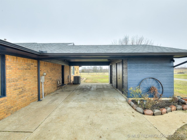 exterior space featuring central AC and a carport