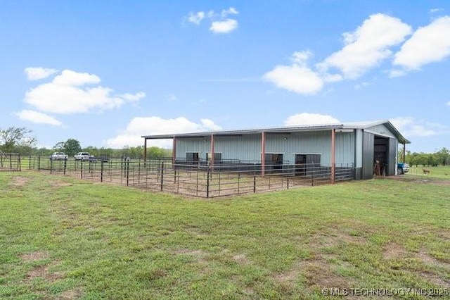 view of horse barn with a rural view