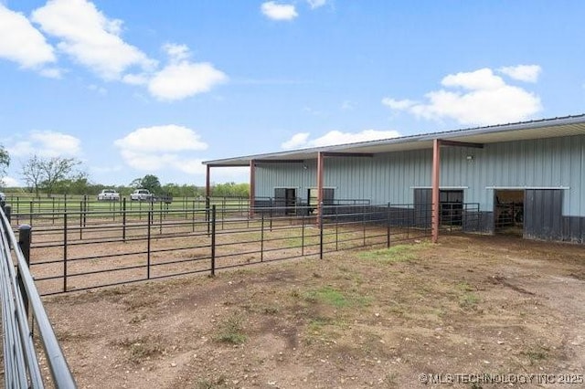 view of yard with an outdoor structure and a rural view