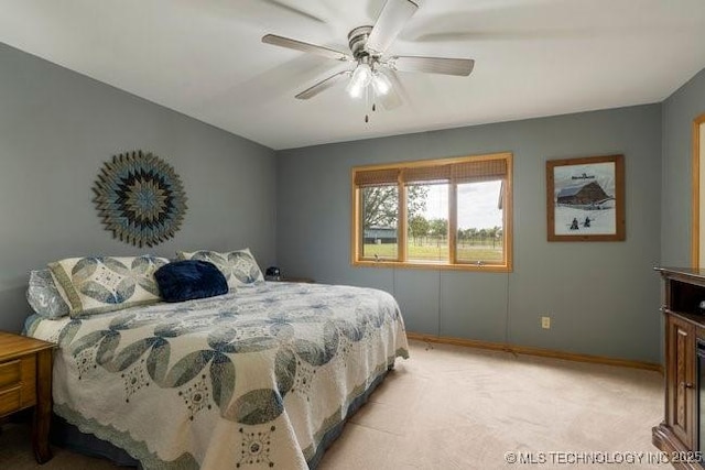 bedroom with baseboards, light carpet, and ceiling fan