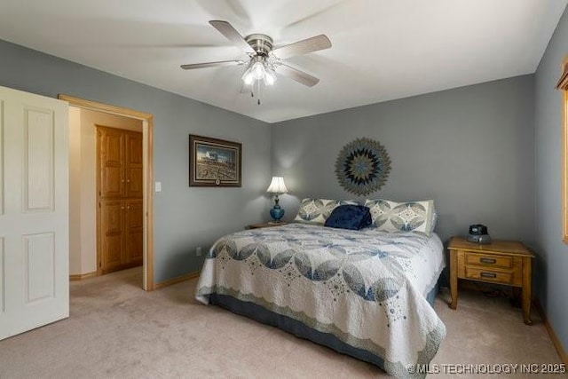 carpeted bedroom featuring a ceiling fan and baseboards