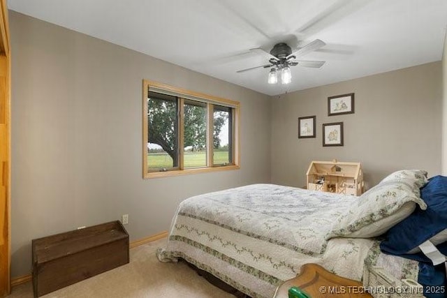 bedroom with carpet, a ceiling fan, and baseboards