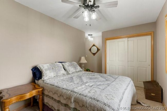 carpeted bedroom with ceiling fan and a closet