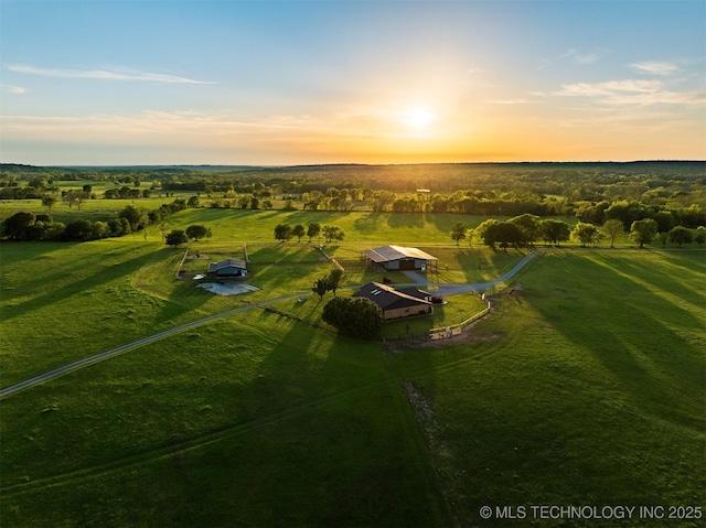 aerial view at dusk featuring a rural view