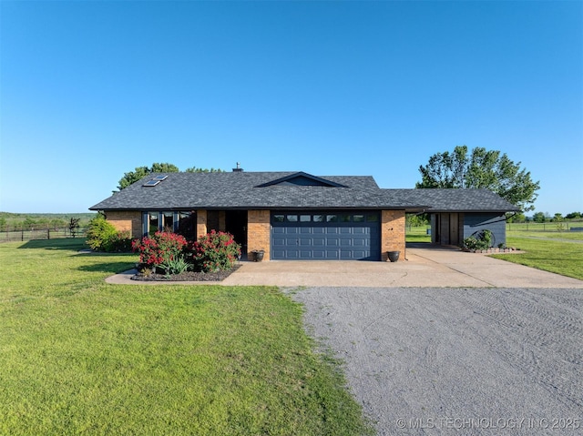 view of front of home featuring a front lawn, a garage, brick siding, concrete driveway, and fence