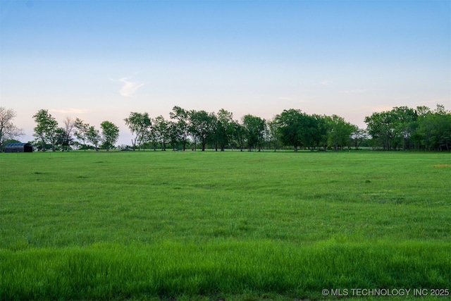 nature at dusk featuring a rural view