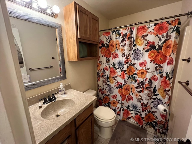 bathroom with vanity, curtained shower, and toilet