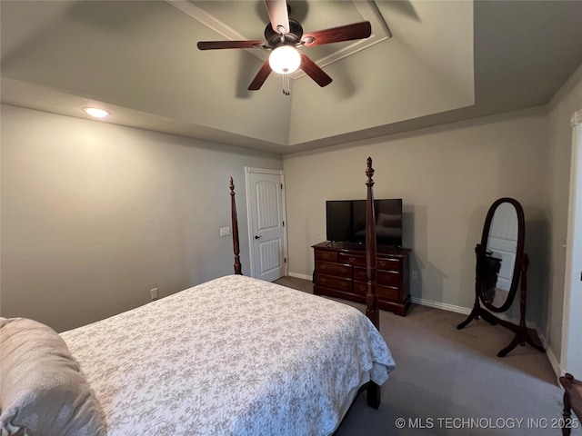 bedroom featuring vaulted ceiling, a raised ceiling, ceiling fan, and carpet