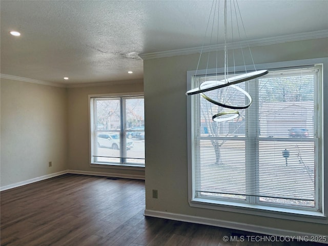 unfurnished dining area featuring dark hardwood / wood-style flooring, crown molding, and a textured ceiling