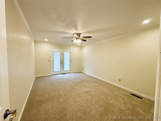 spare room with crown molding, carpet flooring, ceiling fan, and french doors