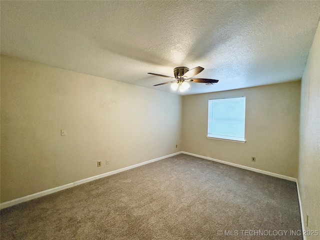 unfurnished room with ceiling fan, dark carpet, and a textured ceiling