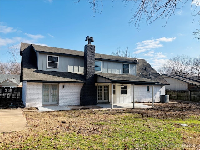 back of house featuring cooling unit, a patio, a yard, and french doors