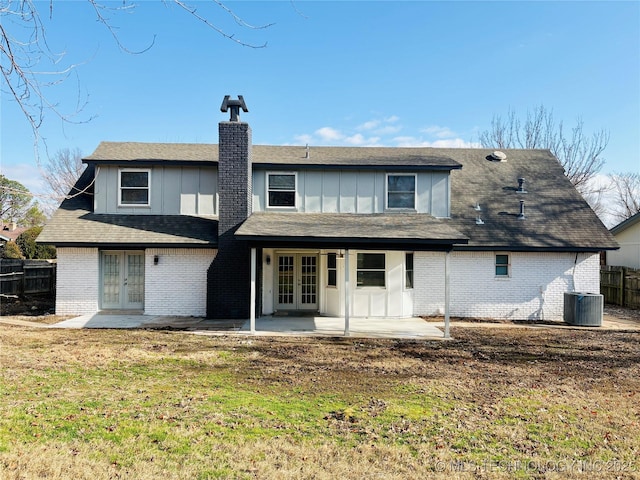 rear view of house with a yard, a patio area, central AC, and french doors