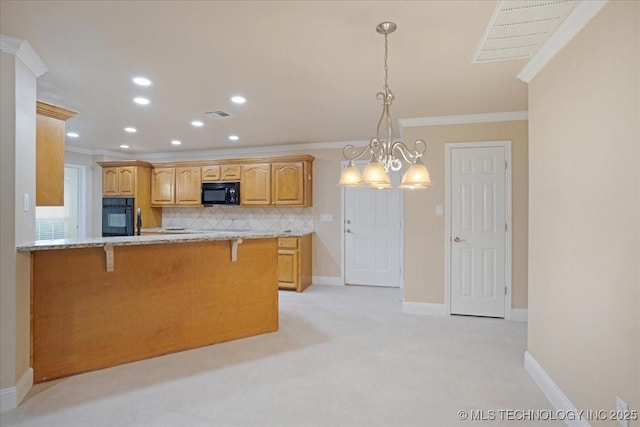 kitchen with hanging light fixtures, ornamental molding, light stone countertops, decorative backsplash, and black appliances