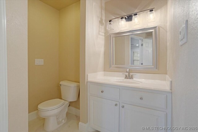 bathroom with tile patterned floors, vanity, and toilet