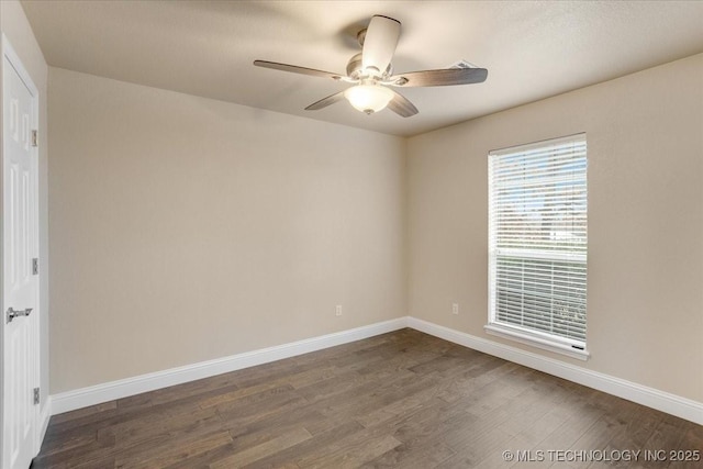 spare room featuring ceiling fan and dark hardwood / wood-style flooring