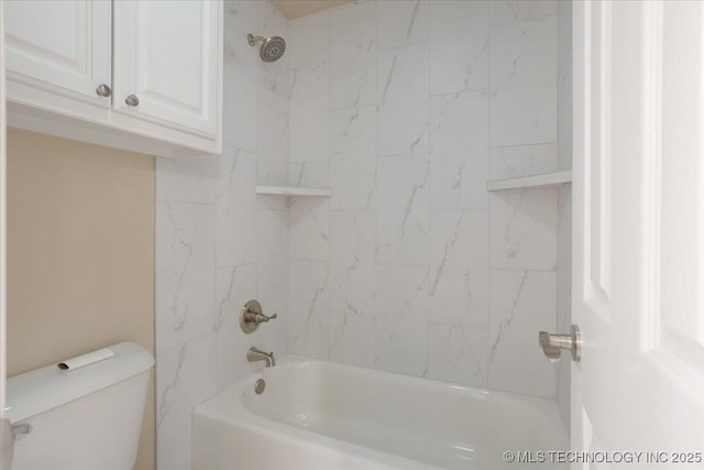 bathroom with tiled shower / bath combo and toilet