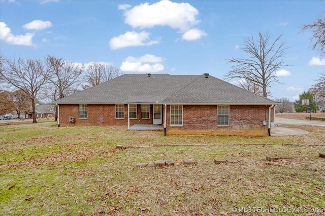 back of property featuring a yard