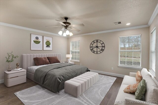 bedroom featuring ceiling fan, ornamental molding, dark hardwood / wood-style flooring, and a textured ceiling