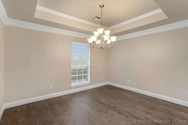 empty room with crown molding, dark hardwood / wood-style floors, a raised ceiling, and an inviting chandelier