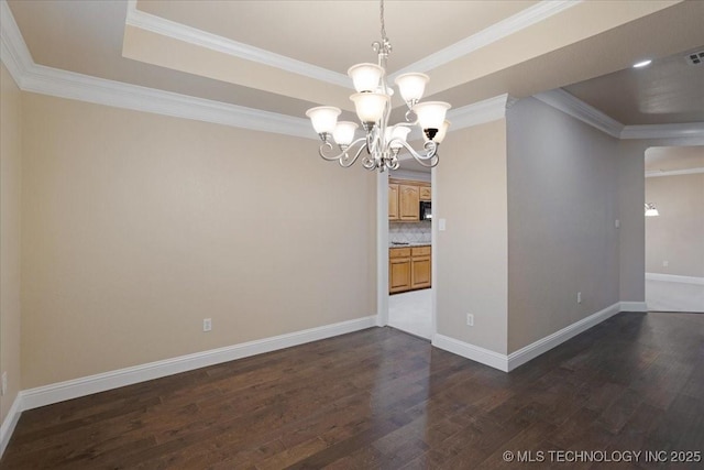 unfurnished dining area with crown molding, dark hardwood / wood-style floors, a notable chandelier, and a tray ceiling