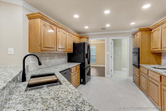 kitchen featuring crown molding, light stone countertops, a sink, black appliances, and backsplash