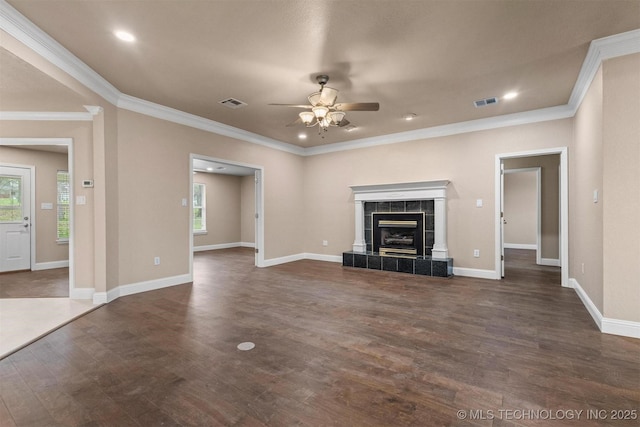 unfurnished living room featuring visible vents, dark wood-style floors, crown molding, and ceiling fan