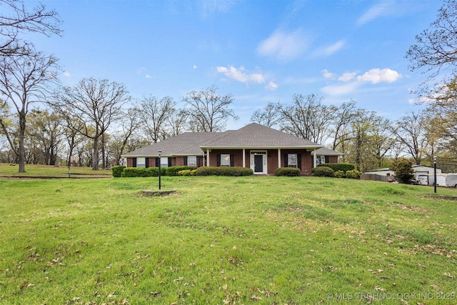 view of front of house with brick siding and a front yard
