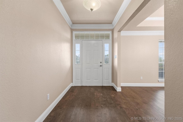 foyer entrance featuring baseboards, a textured wall, ornamental molding, and dark wood-type flooring