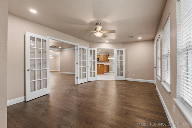 empty room featuring baseboards, dark wood-style floors, french doors, and ceiling fan