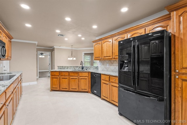 kitchen with ornamental molding, ceiling fan with notable chandelier, visible vents, a peninsula, and black appliances