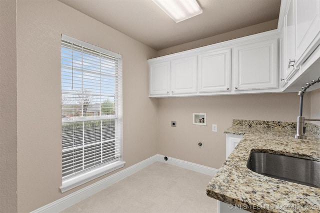 laundry area featuring baseboards, a sink, cabinet space, electric dryer hookup, and washer hookup