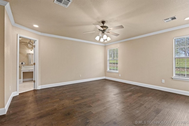 spare room with ornamental molding, dark wood-style floors, ceiling fan, and visible vents