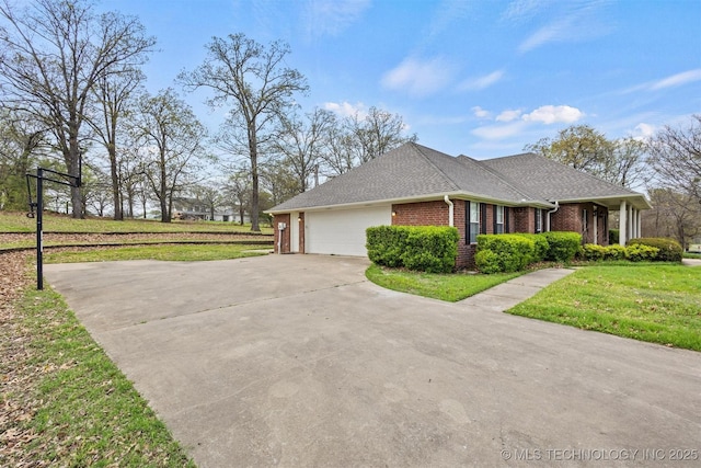 view of property exterior with driveway, brick siding, a shingled roof, a lawn, and a garage
