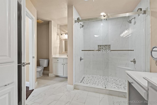 bathroom with toilet, vanity, a marble finish shower, marble finish floor, and baseboards