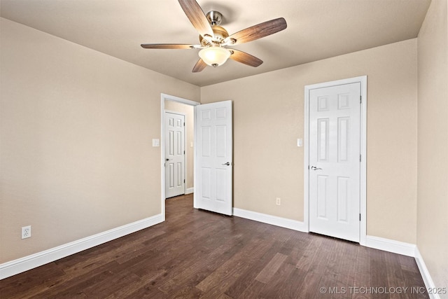 unfurnished bedroom featuring baseboards, a ceiling fan, and dark wood finished floors
