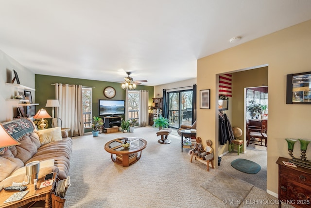 living room featuring light colored carpet and ceiling fan