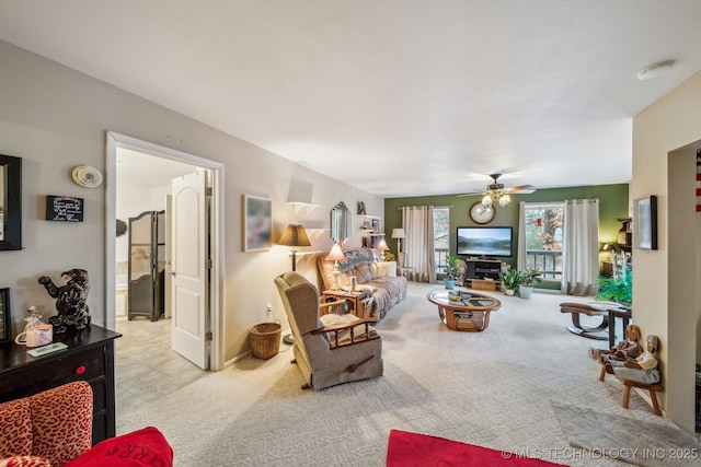 carpeted living room with ceiling fan