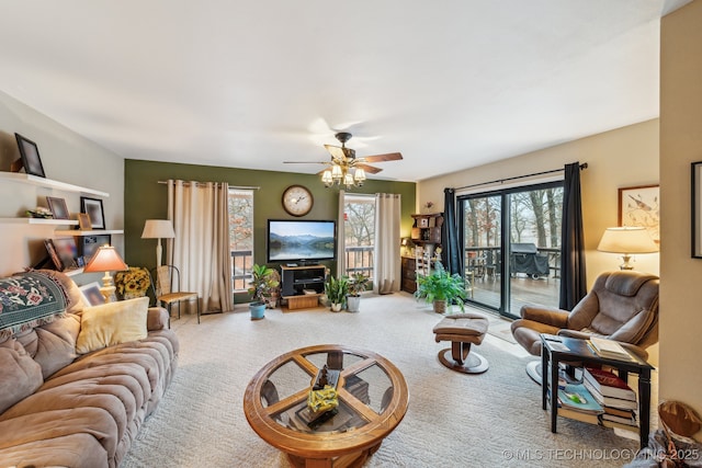 carpeted living room with ceiling fan