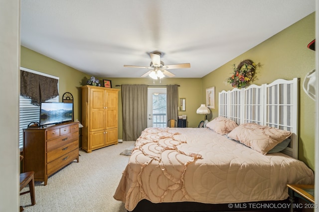 carpeted bedroom featuring access to exterior and ceiling fan