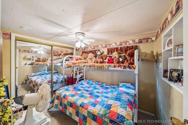 carpeted bedroom featuring ceiling fan and a textured ceiling