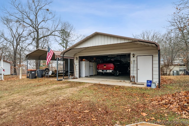 garage featuring a lawn and a carport