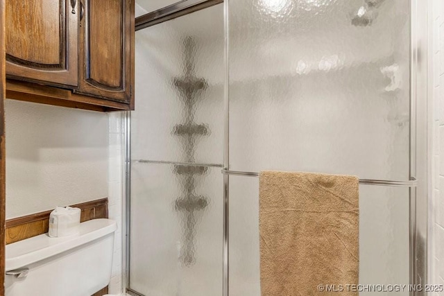 bathroom featuring toilet and walk in shower