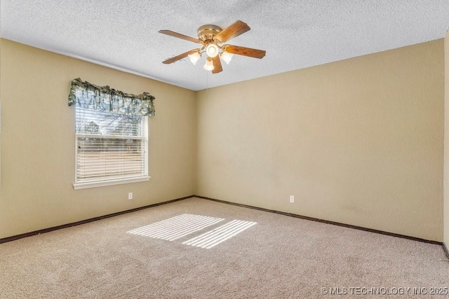 unfurnished room with ceiling fan, light carpet, and a textured ceiling