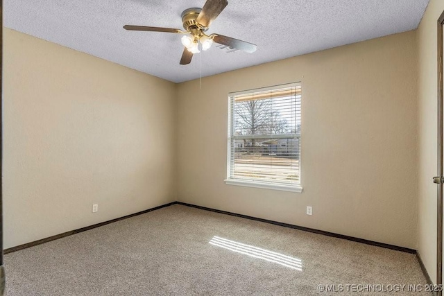 carpeted spare room with ceiling fan and a textured ceiling