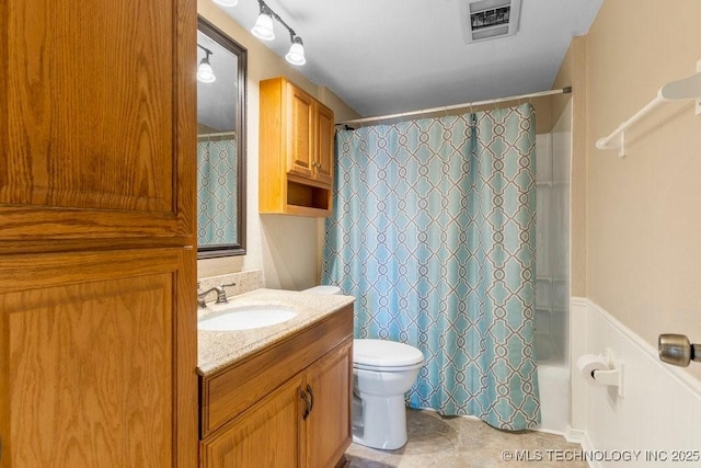 full bathroom featuring vanity, shower / bath combination with curtain, and toilet